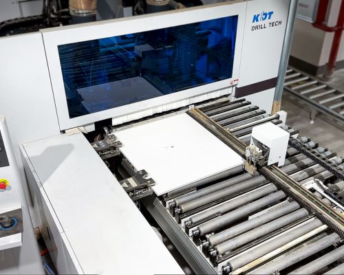 A panel with a QR code sticker on the production line at Jilphar Home’s kitchen cabinet factory, about to enter a machine that will scan the QR code and drill precisely at the designated positions based on the information provided.